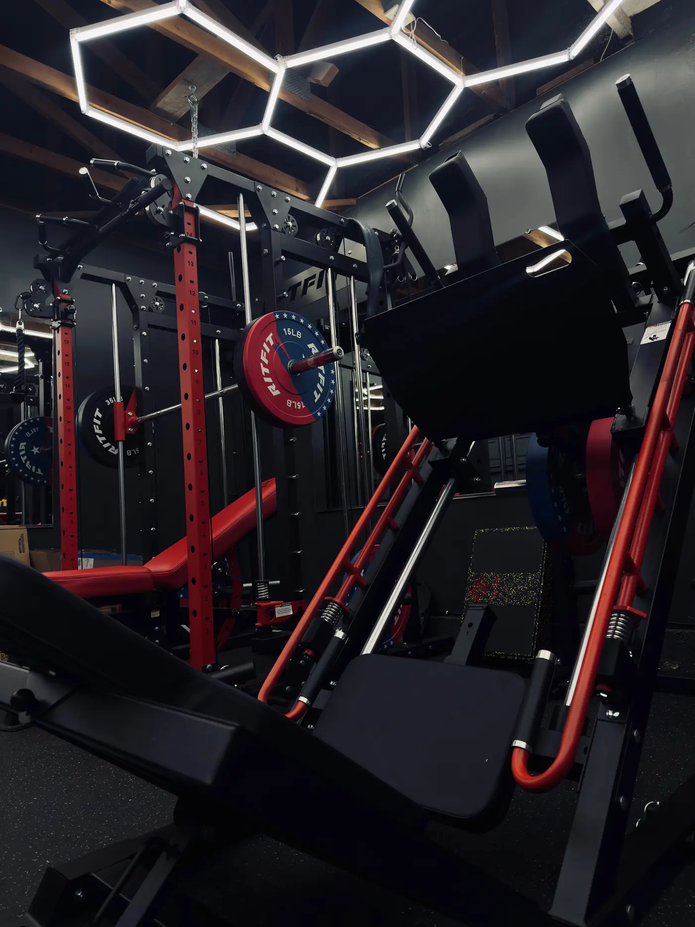 Bench and adjustable dumbbells in a finished garage gym